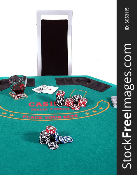 A poker table with chips a drink and cards. A chair invites to sit down. Isolated over white.