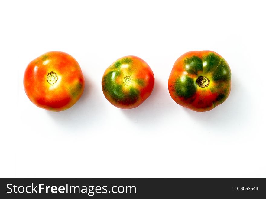 An image of three tomatos on white background. An image of three tomatos on white background