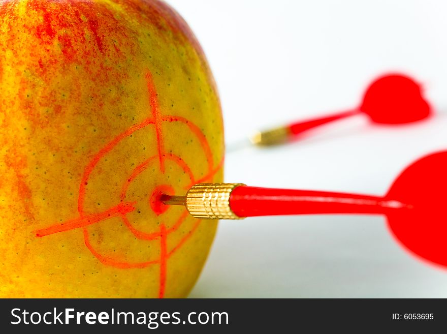 Red-yellow Apple with Darts closeup on White Background. Red-yellow Apple with Darts closeup on White Background