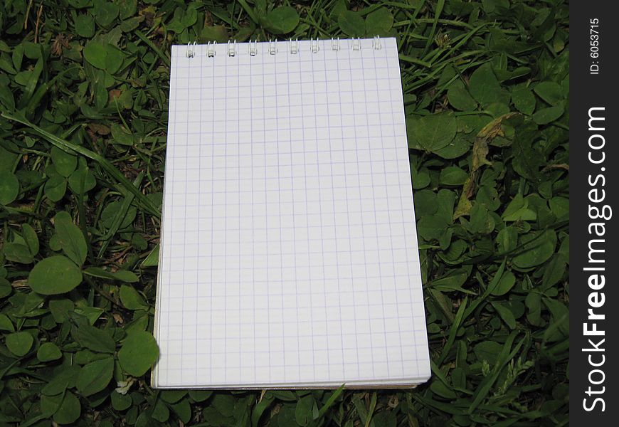 Office notepad on the grass