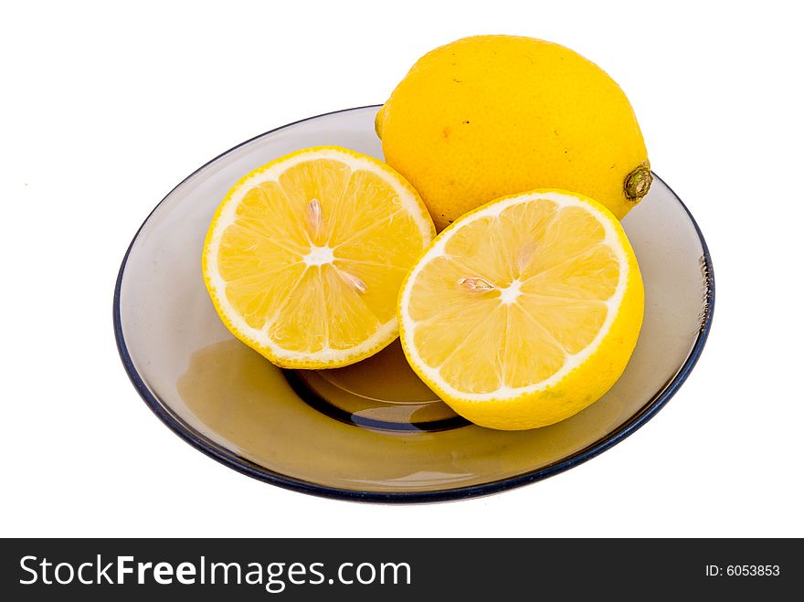 Yellow cut clean lemons on the saucer isolated on white. Yellow cut clean lemons on the saucer isolated on white