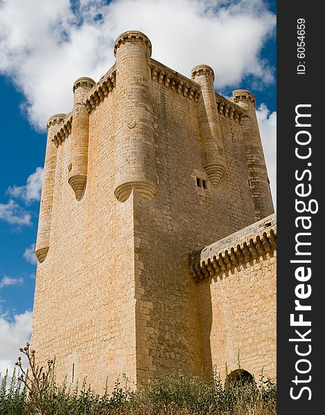 Perspective view of Torrelobaton castle main tower. It is located in a small village in Valladolid (Spain). It is over a small hill and dominates a wide plane. Most of this castles in Castilla played a fundamental role during the war between christians and muslims in the Middle Age. Perspective view of Torrelobaton castle main tower. It is located in a small village in Valladolid (Spain). It is over a small hill and dominates a wide plane. Most of this castles in Castilla played a fundamental role during the war between christians and muslims in the Middle Age.