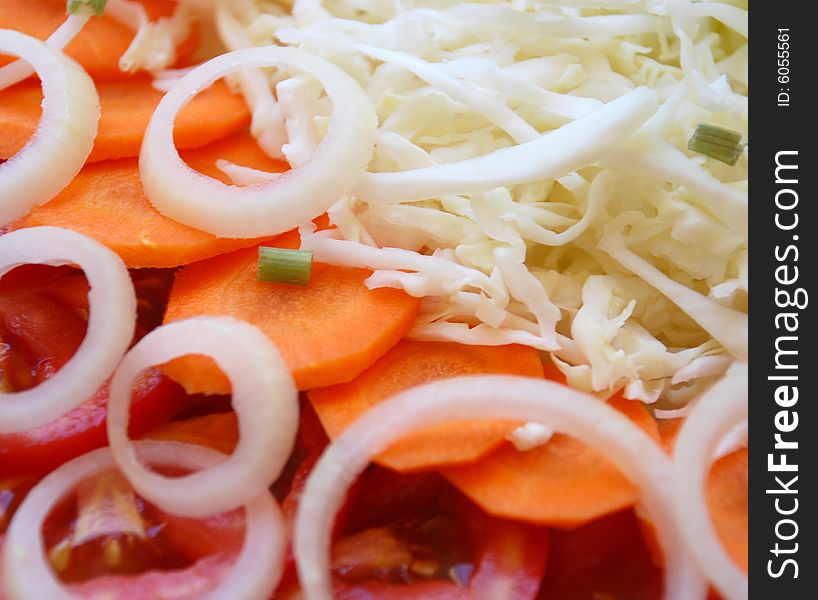 A detail of a fresh salad with carrot and onion