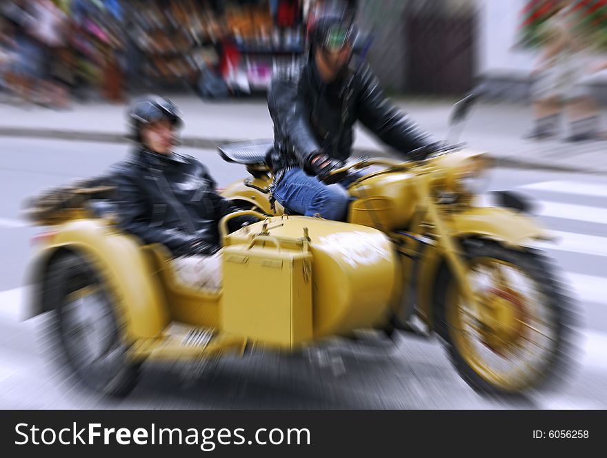 Photo of the couple riding an old motorbike