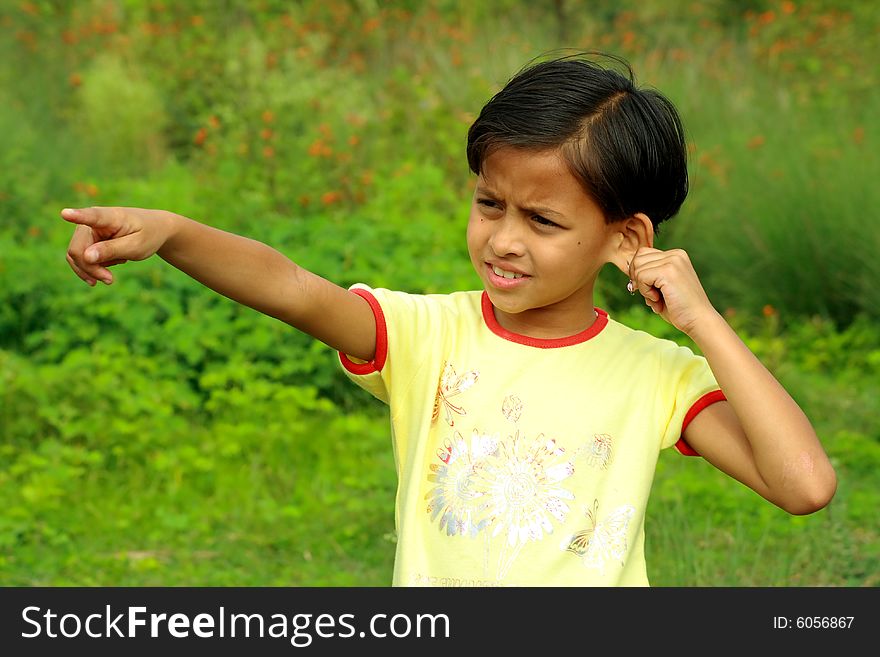 A girl pointing finger at some distant object. A girl pointing finger at some distant object.