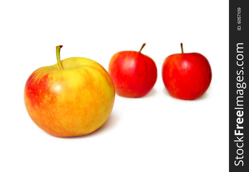 Two red and one yellow apples isolated on white background
