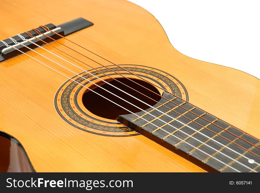 Classical acoustic guitar isolated over a white background