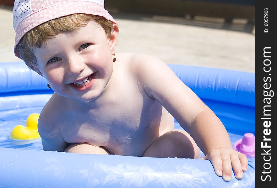 Cute baby girl having fun in the pool. Cute baby girl having fun in the pool