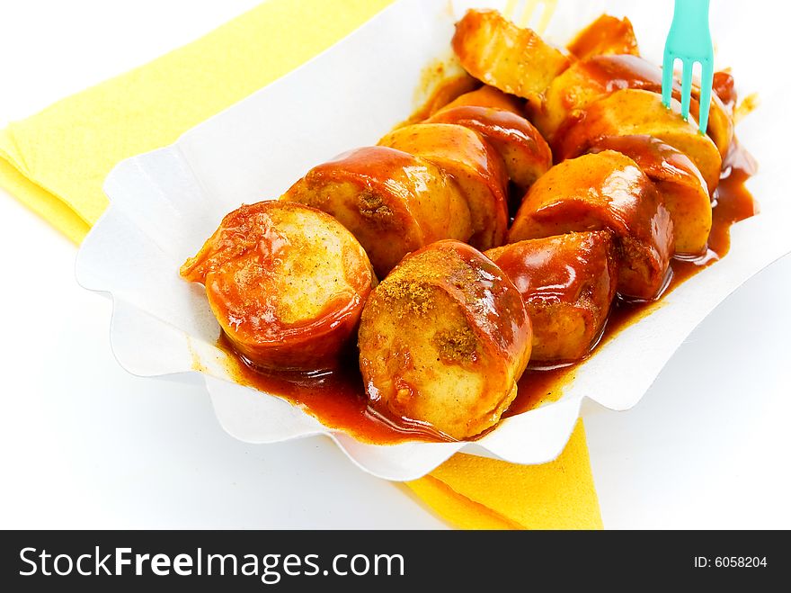 Frying sausage with ketchup-isolated on white.