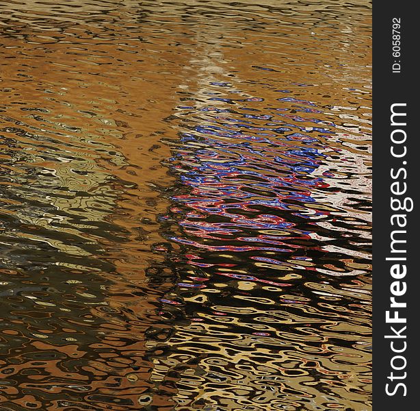 Golden reflections of the sun on ripples in a tidal area creating an abstract