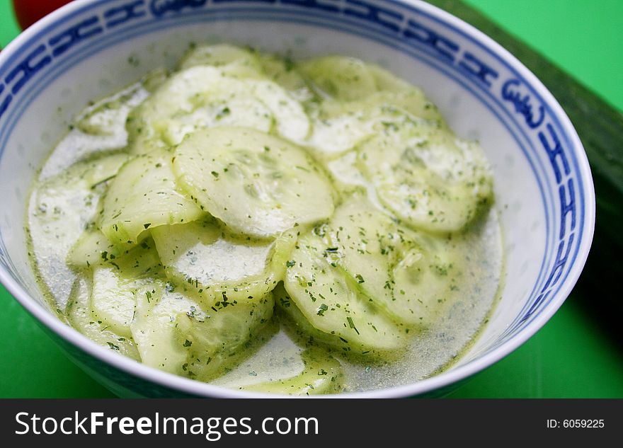 Fresh salad of cucumbers with oil and vinegar