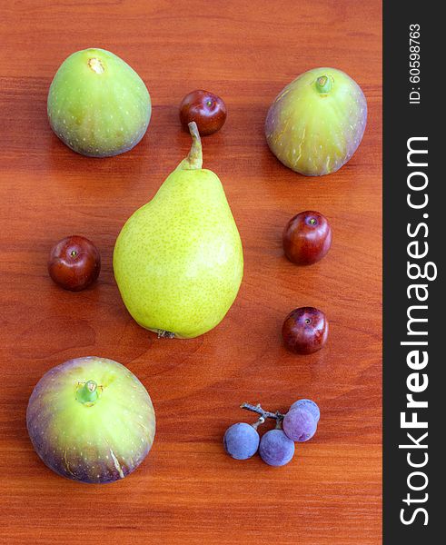 Fresh fruits on wooden background closeup