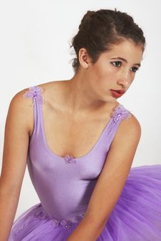 Sitting Young Ballerina In Purple Tutu Royalty Free Stock Photos