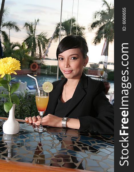 Girl in business suit enjoy cocktail at bar. Girl in business suit enjoy cocktail at bar