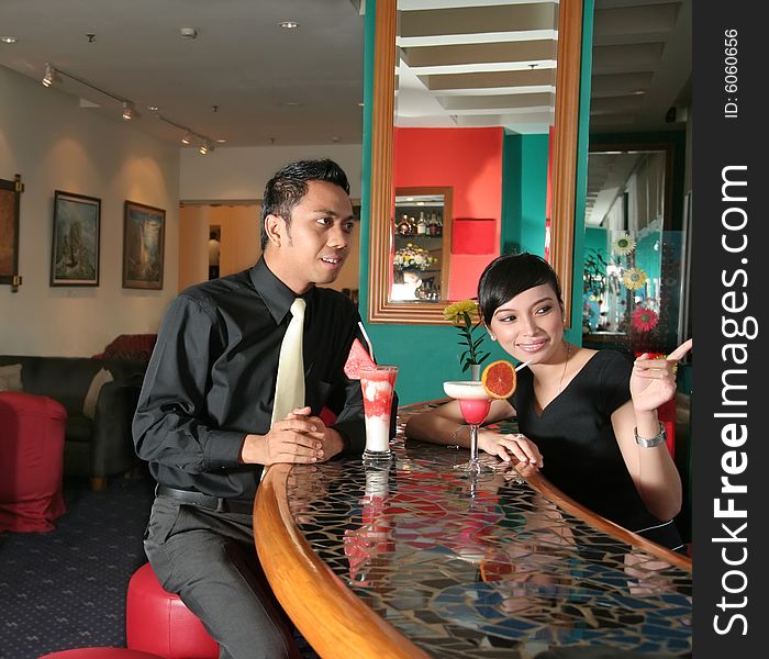 Couple at bar or lounge with cocktail