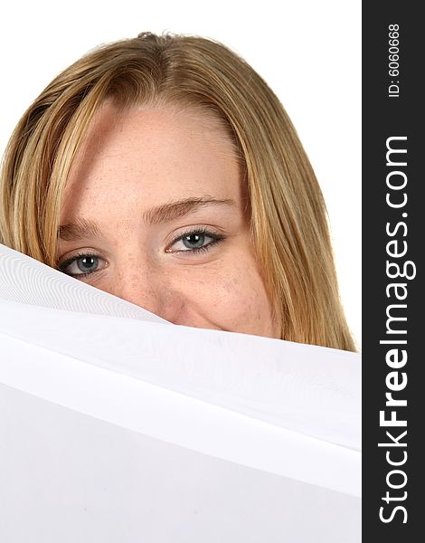 Woman peeking over white pillow. Woman peeking over white pillow