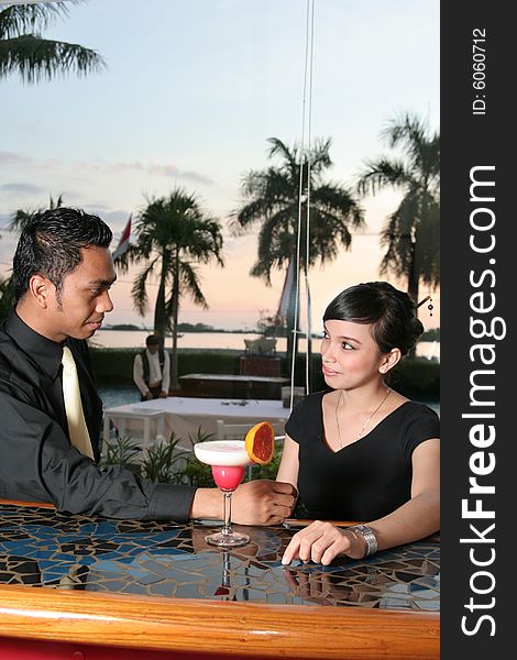Couple at bar or lounge with cocktail