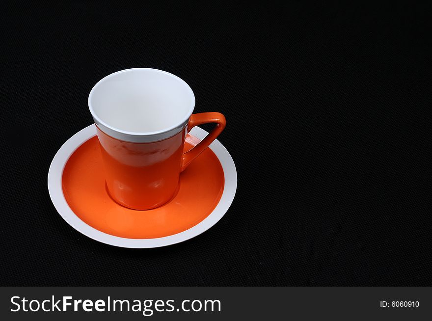 Image of orange cup and saucer. Image of orange cup and saucer