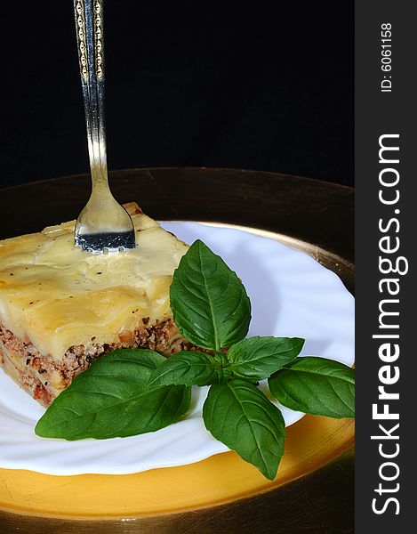 Tasty lasagne with basil leaf