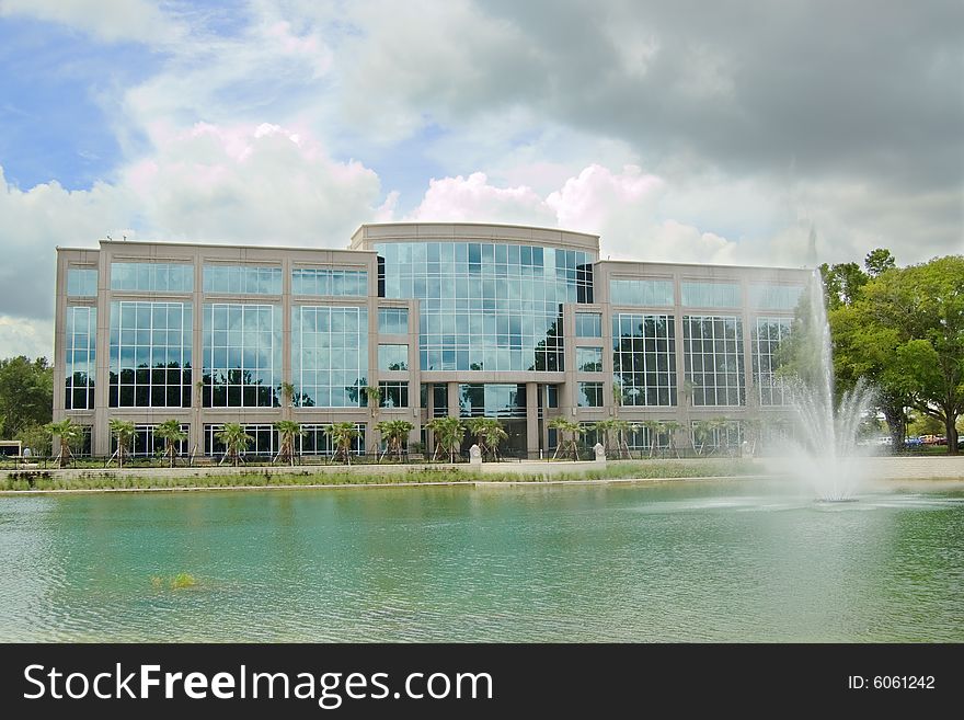 Office building with fountain and dark cloud. Office building with fountain and dark cloud.