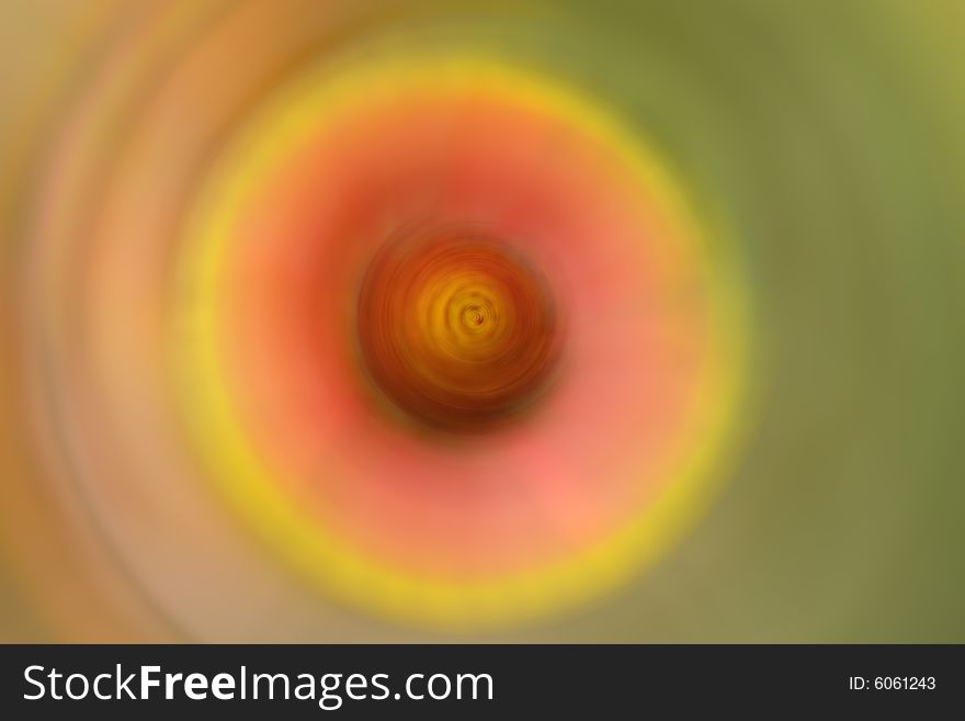 A whirling circular abstract background consisting of red, green, orange and yellow sections. A whirling circular abstract background consisting of red, green, orange and yellow sections.