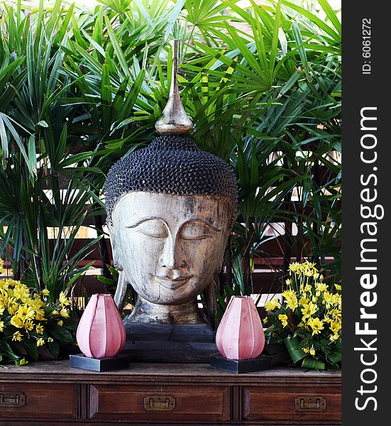 Buddhist sculpture with flowers in Thailand - travel and tourism. Buddhist sculpture with flowers in Thailand - travel and tourism.