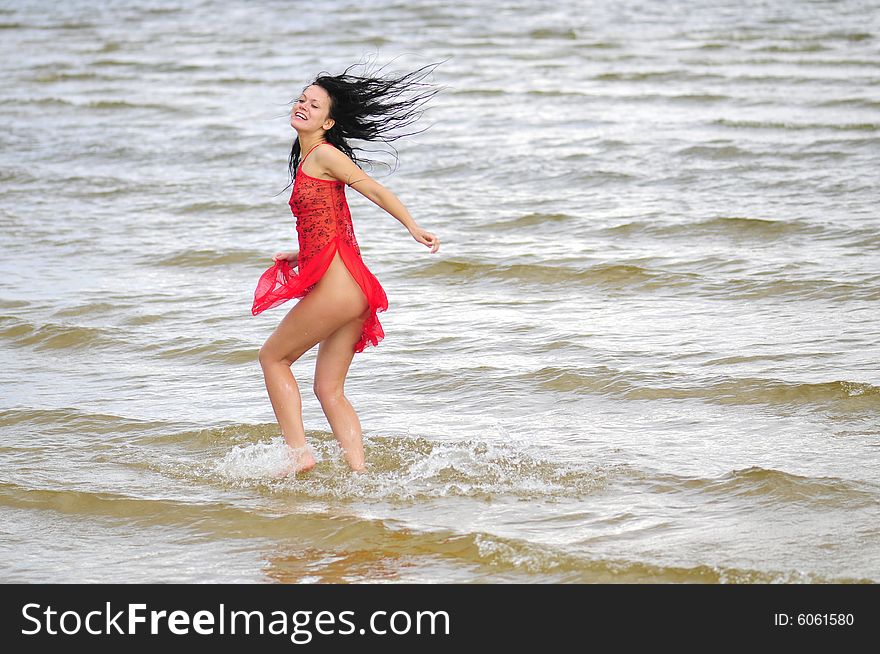 Happy Woman Dancing On The Beach