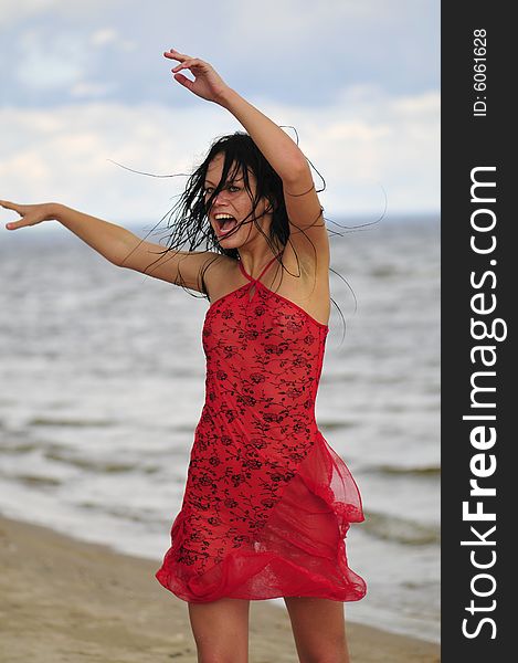 Happy woman dancing on the beach
