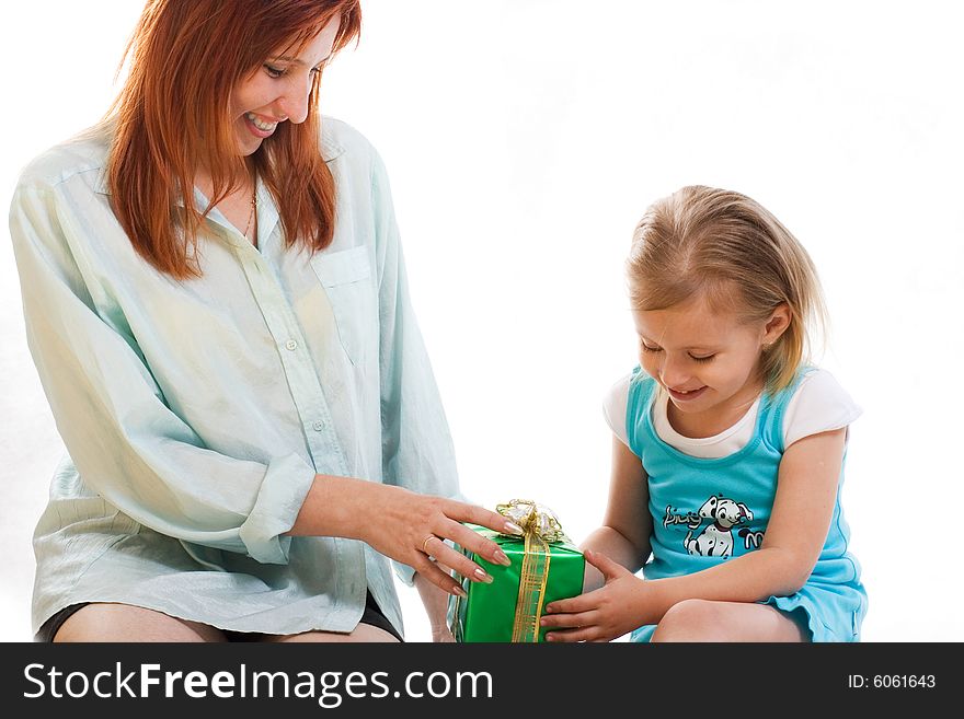 Mum gives the daughter a gift. Mum gives the daughter a gift