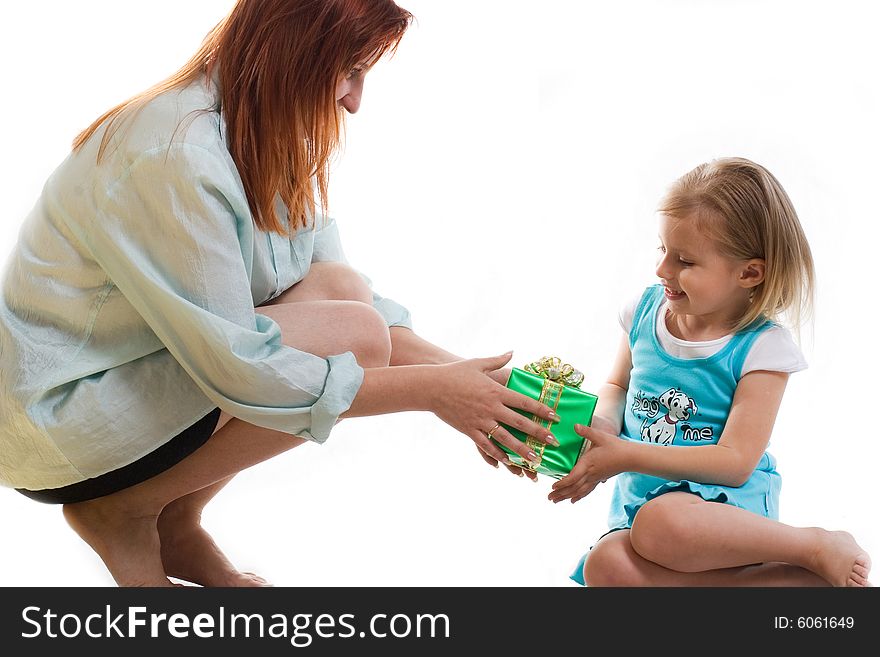 Mum gives the daughter a gift. Mum gives the daughter a gift