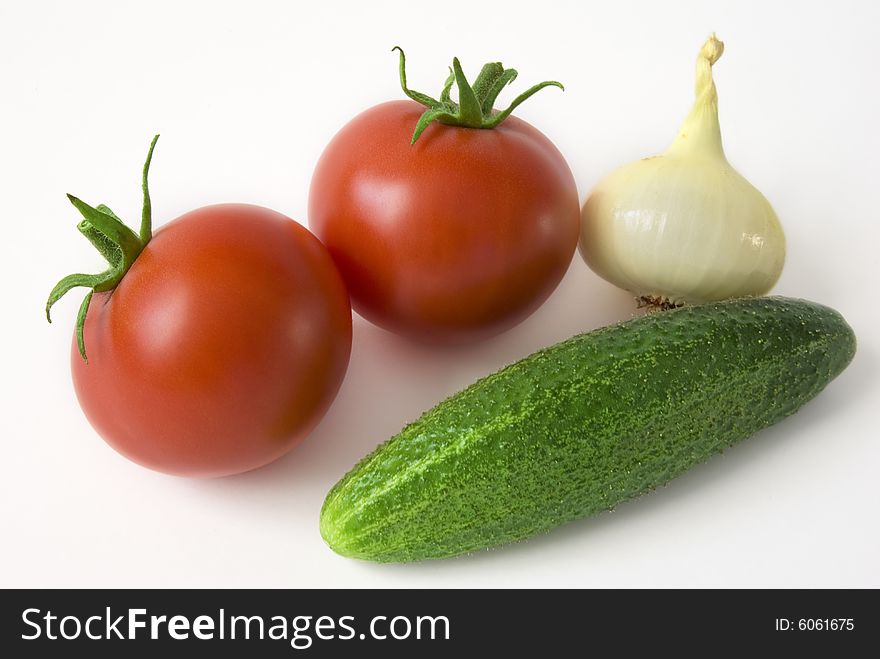 Tomatoes, onion and cucumber on the white background