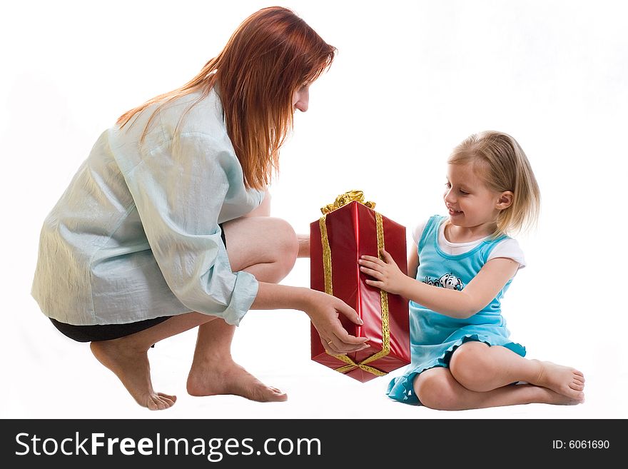 Mum gives the daughter a gift. Mum gives the daughter a gift