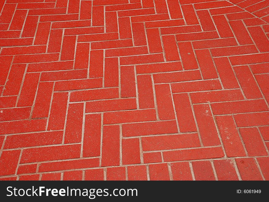 A Herringbone pattern in bricks used to create an outdoor patio