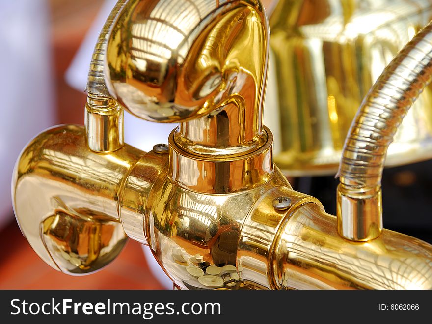 Macro shot of hardware attached to a golden espresso machine. Macro shot of hardware attached to a golden espresso machine