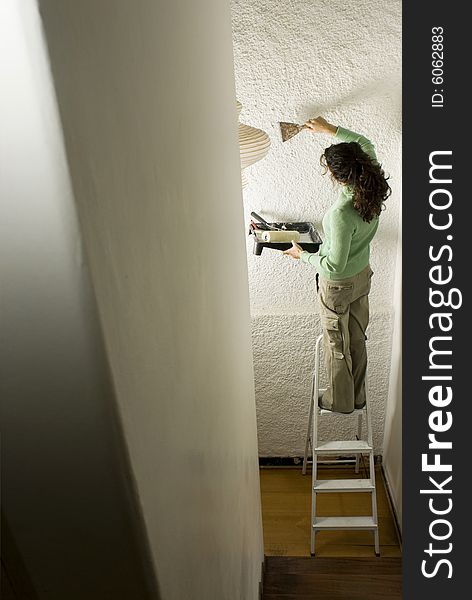 Woman Scraping Wall - Vertical