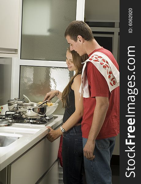 Couple Cooks In Kitchen - Vertical