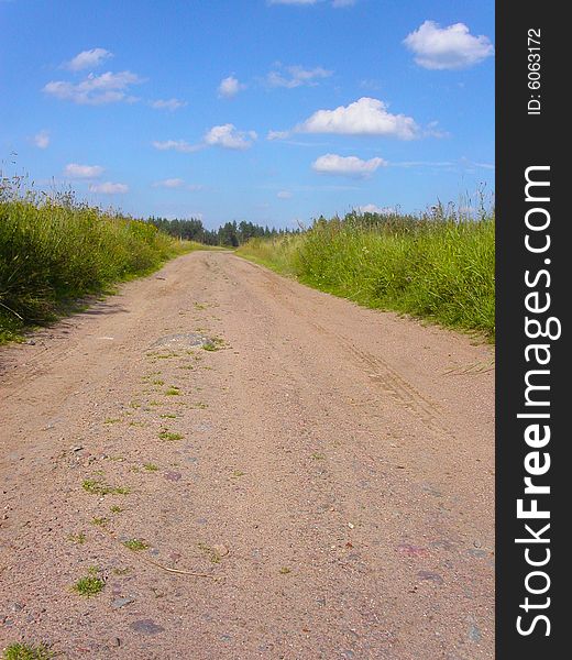 Soil road through a field