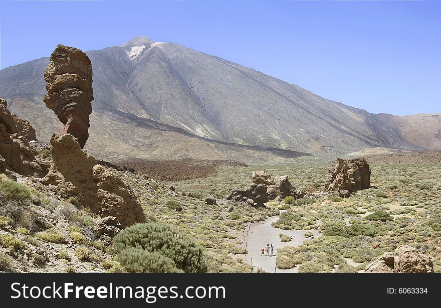 A young family going for a walk at the base of Mount Teide