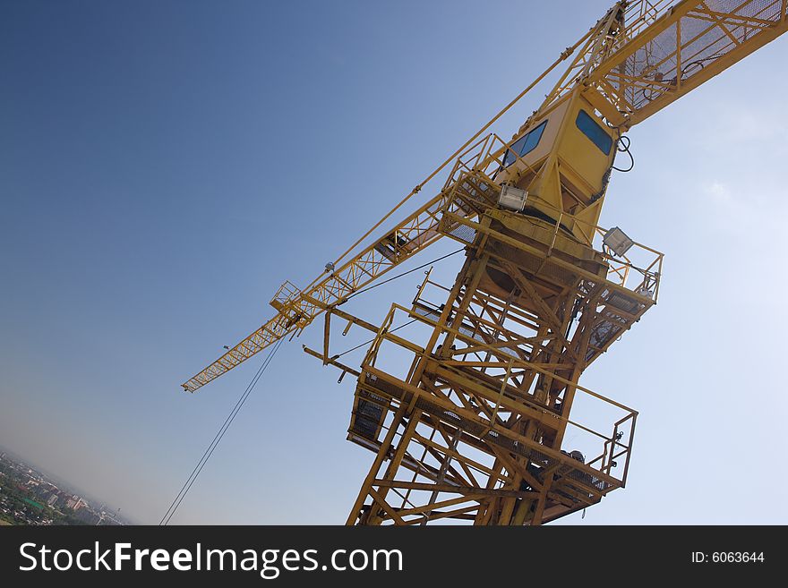 Tall building crane over blue sky