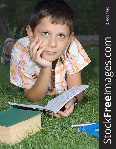 Boy doing  home work outdoor