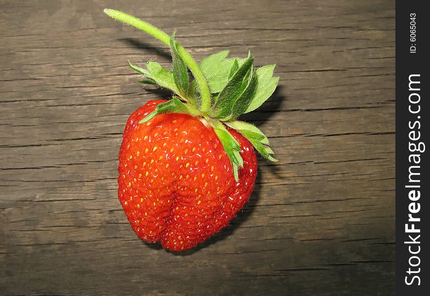 Red color  berry of  strawberry on  surface of  wooden board