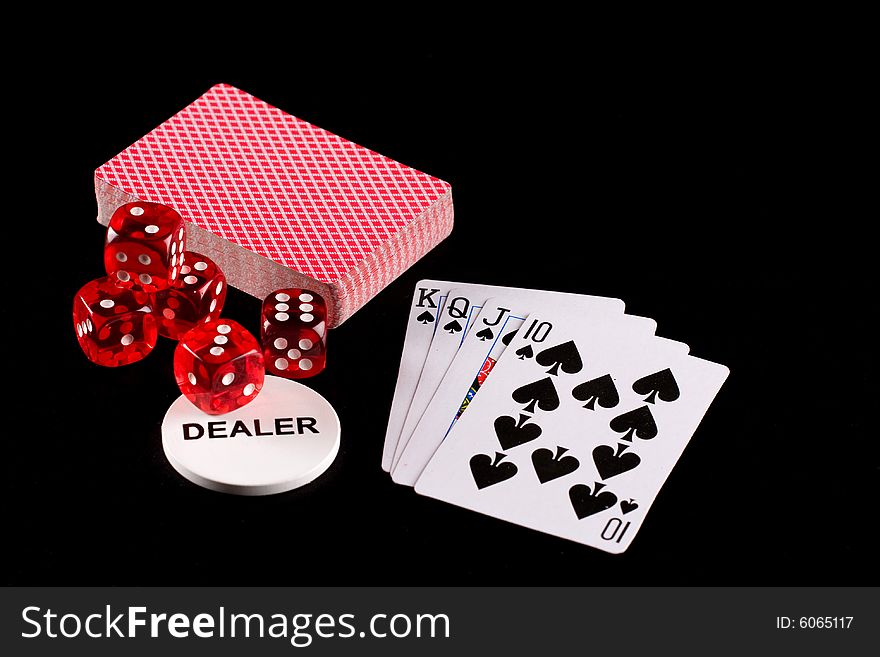 Playing cards and dice on a black background