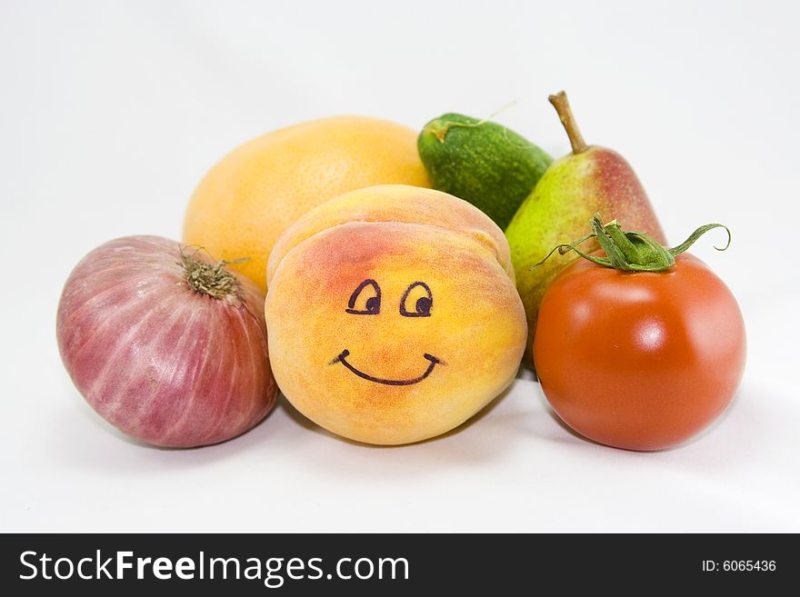 Smiling peach and other fruit and vegetables on a white background. Smiling peach and other fruit and vegetables on a white background.