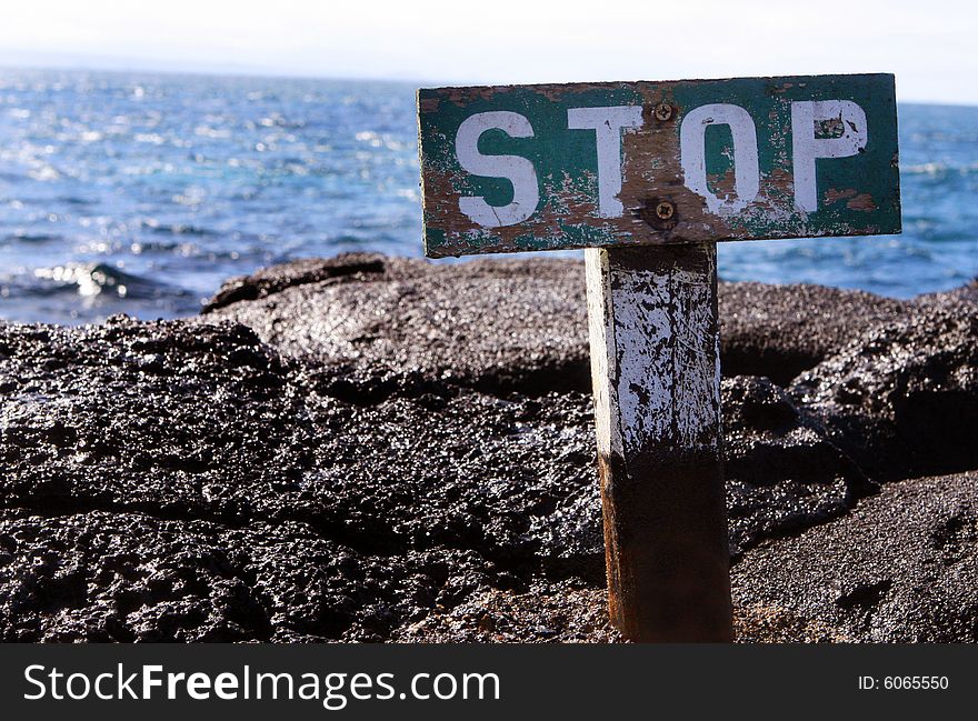 This stop sign warns visitors to stay away from the edge of the rocky bluff. This stop sign warns visitors to stay away from the edge of the rocky bluff