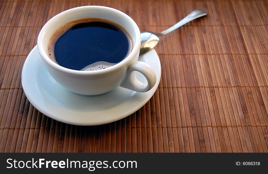Morning coffee cup on brown wooden background