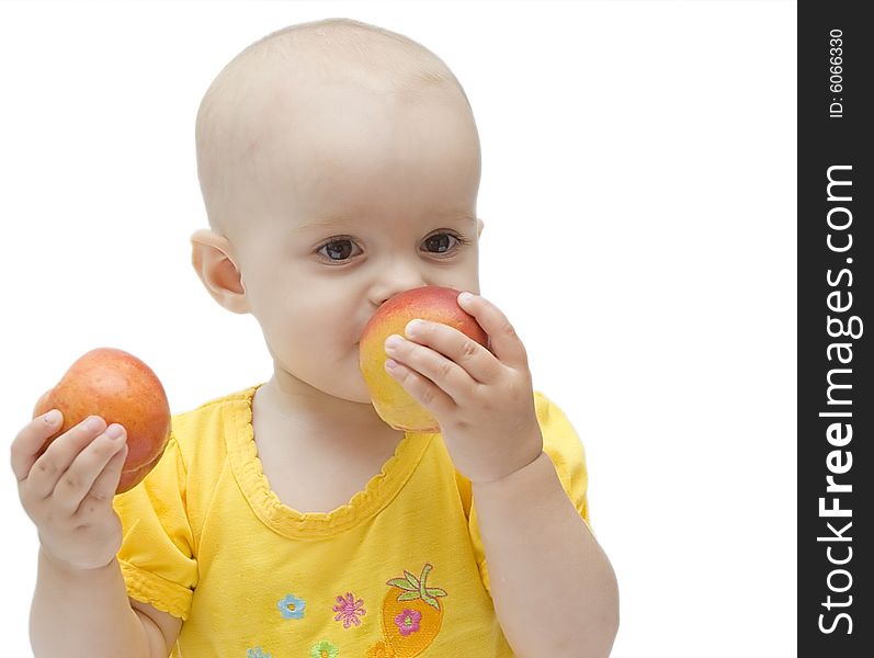 Little baby girl in yellow eating peaches. Little baby girl in yellow eating peaches