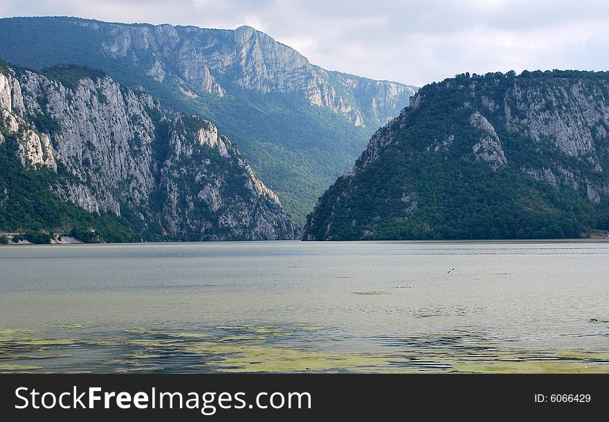 A picture of mountain river with dark clouds