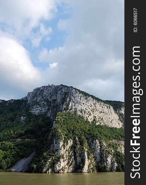 A picture of mountain river with dark clouds