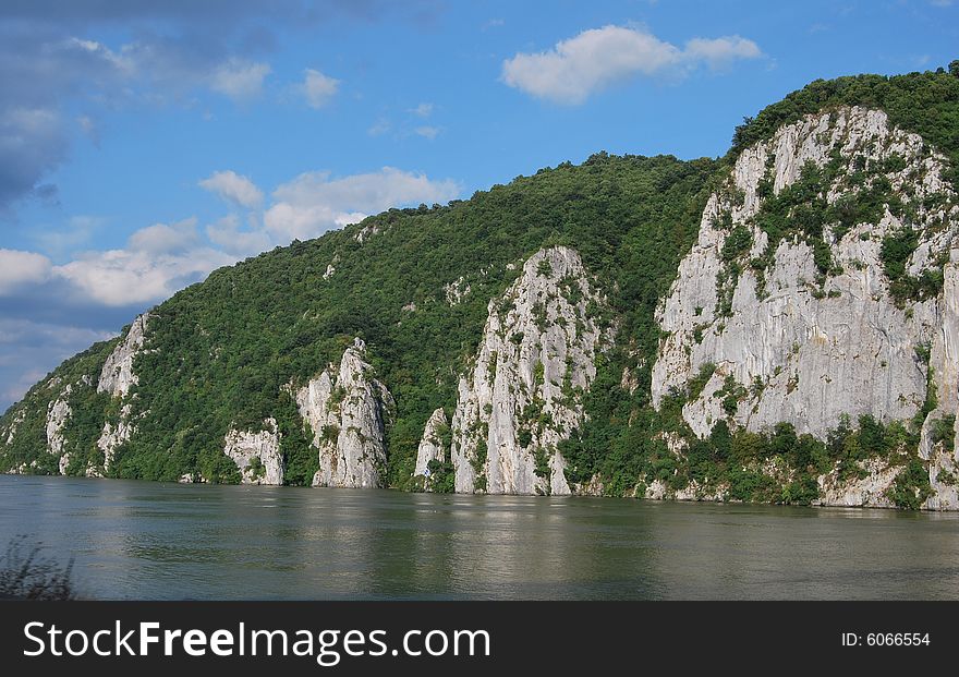 A picture of mountain river with white clouds