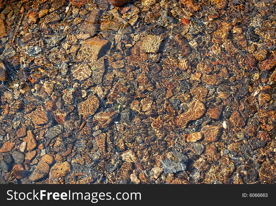 Stones in water. Wet river rocks